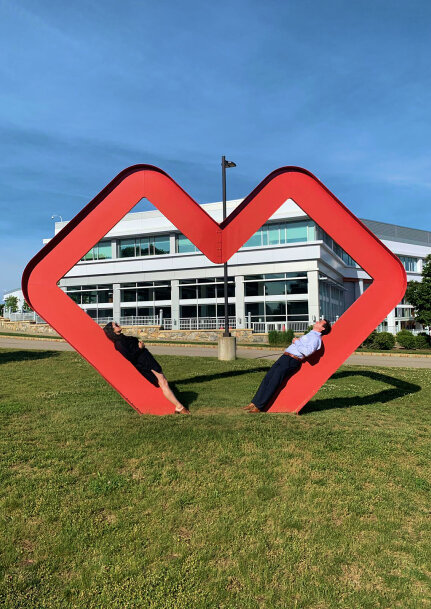 founders posing in heart sculpture