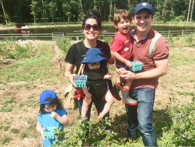 Jonathan and Kejal apple picking with the kidds.